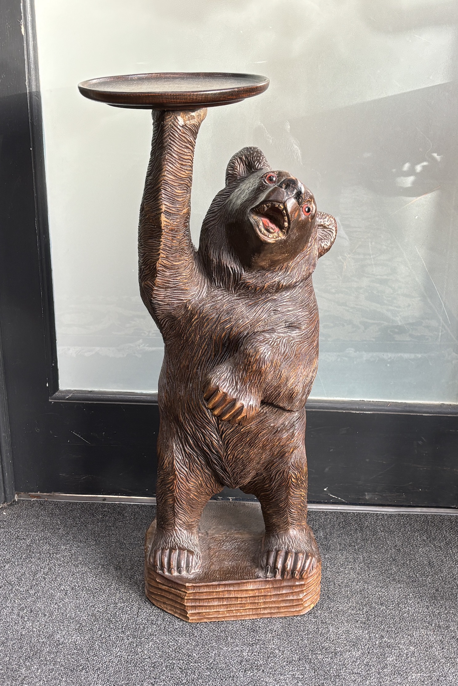 A large Black Forest figure of a bear, with later oak dish top, 71cm high